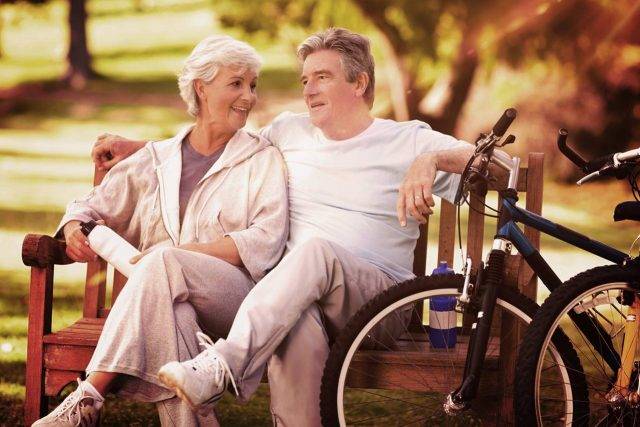 Older Couple Bench Bikes